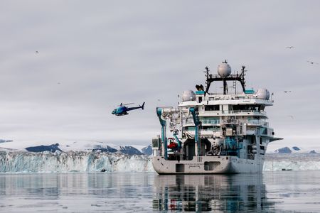 The helicopter flies away from the OceanXplorer. (National Geographic/Mario Tadinac)