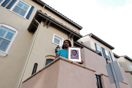 Shauna Dade holds a portrait of her father, Floyd Dade, outside her home in San Marco, Calif. Corporal Floyd Dade served with the 761st Black Panther Tank Battalion in WW2. (National Geographic/Fabian Mandujano)