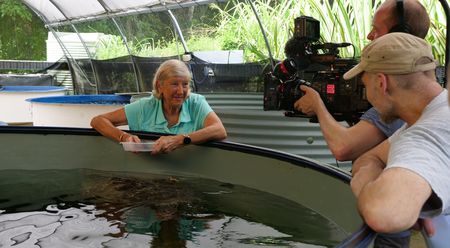 Jennie with a turtle in its enclosure. (Big Wave Productions)