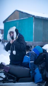 Tinmiaq Hailstone prepares to take a sleeping Sabastian on a snowmobile ride to their family property to fish during the winter season. (BBC Studios Reality Productions, LLC/Pedro Delbrey)