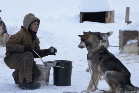 Denise Becker feeds their dogs during the winter season. (BBC Studios Reality Productions, LLC/JR Masters)
