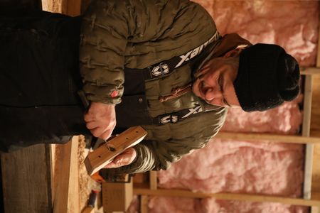 Chip Hailstone works on crafting and shaping wood for his sled. (BBC Studios Reality Productions, LLC/JR Masters)