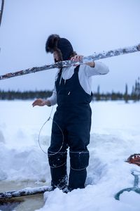 Ricko DeWilde sets a beaver trap under the ice. (BBC Studios Reality Productions/v)