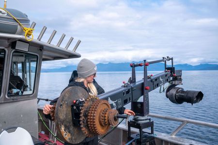 Shotover technician Katie Vickers operates the jib in order to film humpback whales. (National Geographic for Disney/Paul Satchell)