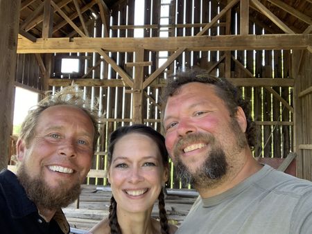 Ben Reinhold, Beth Pol, and Charles Pol smile while at the old barn they are taking down. (National Geographic)