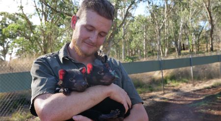 Tyler holding two  tasmanian devil babies. (Big Wave Productions)