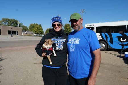 Drs. Erin and Ben Schroeder smile with their dog Happy before the 5K fundraiser for Wynot Public School's Agricultural Tech program. (National Geographic)