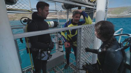 Experts Ryan Parker, Charlie Huveneers and Melissa Marquez discussing the aftermath of their recent dive to assess a large Great White shark in the water. (National Geographic/Jonathan Shaw)