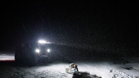 Sue Aikens gathers fresh water while traveling towards Kavik River Camp. (BBC Studios/Michael Cheeseman)