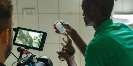 BTS of Beyan Borbor feeding the Wallah the pangolin. (Big Wave Productions)