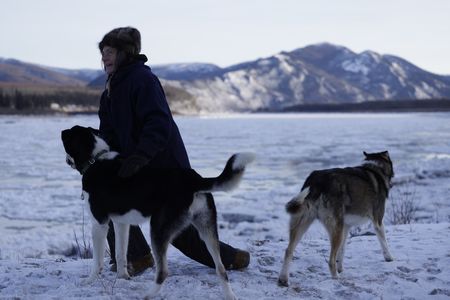 Denise Becker with her dogs next to the Yukon River. (BBC Studios Reality Productions, LLC/Alan Hanna)