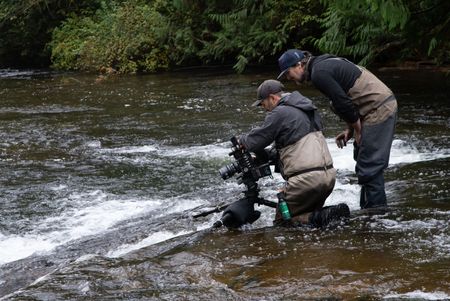 Crew suspend a camera on a jib for filming spawning salmon. (National Geographic for Disney/Ambrose Weingart)