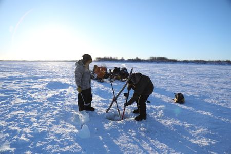 Brothers, Avery and Gage Hoffman set fish nets under the ice for subsistence food for their family and community. (BBC Studios Reality Productions, LLC/Isaiah Branch - Boyle)