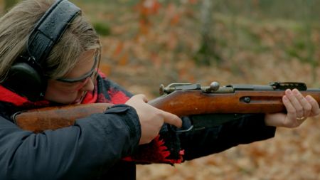 Alina aiming gun. (National Geographic)