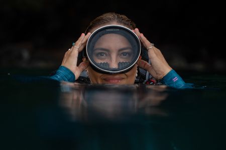 Dr Alex Schnell adjusts her dive mask on the surface while snorkeling in Lembeh Strait.  (National Geographic for Disney/Craig Parry)