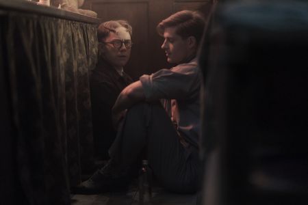 A SMALL LIGHT - Jan, played by Joe Cole, and Willem, played by Sean Hart, take cover during an air raid, as seen in A SMALL LIGHT. (Credit: National Geographic for Disney/Martin Mlaka)