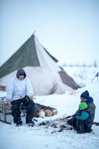 Agnes Hailstone shows her grandson Sabastian how to pluck ptarmigan, with the help of her husband, Chip Hailstone. (BBC Studios Reality Productions/Ashton Hurlburt)