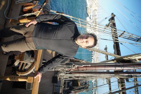 Claudio Lozano stands on the deck of a Puntales ship, standing by the wheel of the ship. The ship was used to defend against the french navy in the penninsular war in Spain. (National Geographic/Ciaran Henry)