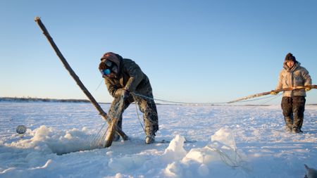 Gage and Avery Hoffman check their nets for fish. (BBC Studios/Danny Day)