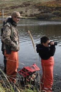 Justin Phillips and his son, Isaac Phillips look for seals while hunting. (National Geographic/Lauren "Bird" Dixon)