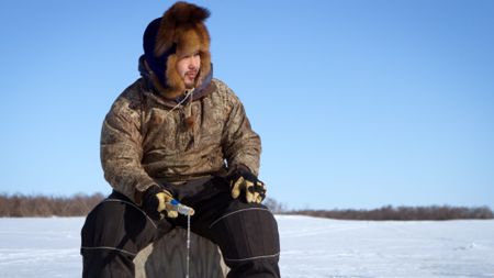 Gage Hoffman ice fishes with his brother and cousin. (BBC Studios/Brian Bitterfeld)