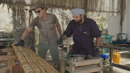 Maritime archaeologist Alessandro Ghidoni and craftsman Ayaz Al-Zadjali work on location in Qantab, Oman. (Windfall Films)