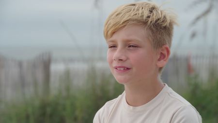 Brian Sites Jr being interviewed on the beach and recalling him witnessing his grandmother being attacked by a shark. (National Geographic)