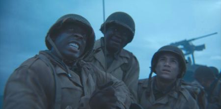 Soldiers help Corporal William Dabney (played by Joshua Riley) raise the barrage balloon in a scene of a WW2 historic reenactment production for "Erased: WW2's Heroes of Color."  Corporal Dabney served with the 320th Barrage Balloon Battalion on D-Day. (National Geographic)