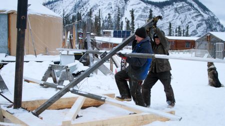 Andy Bassich and Denise Becker construct solar array panels for their property. (BBC Studios/Ben Mullin)