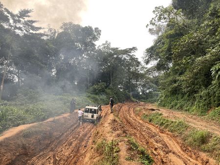 The crew vehicle is stuck in the mud in rebel territory in the Democratic Republic of the Congo. (National Geographic for Disney)