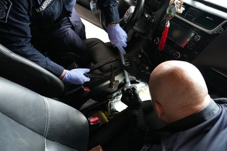 CBP Officers Torres and Ramirez work together to access smuggled contraband hidden inside of a suspect's vehicle in Brownsville, Texas. (National Geographic)