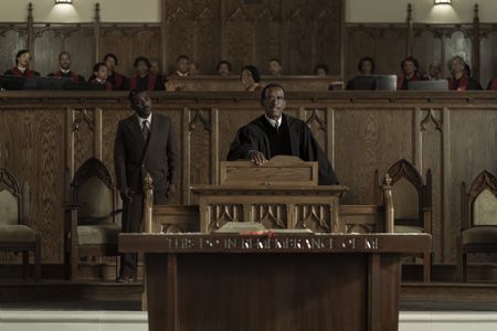 Daddy King, played by Lennie James, preaches behind the pulpit in GENIUS: MLK/X. (National Geographic/Richard DuCree)