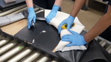 CBP Supervisory Officers Keller and Pirollo take apart a shipped ottoman and find a white powdery substance hidden inside its lining in Philadelphia. (National Geographic)