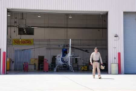 Air Enforcement Agent Murray  walks across a tarmac to a CBP air vehicle in San Diego, Calif. (National Geographic)