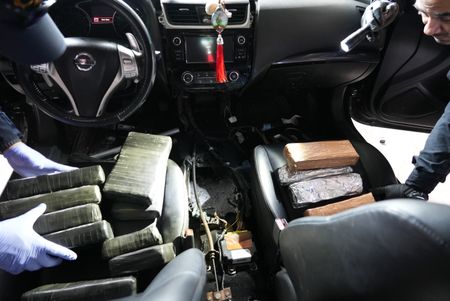 Multiple packages of suspected narcotics are sitting on the driver's seat and passenger seat of a suspect's vehicle after they were found smuggled  in Brownsville, Texas. (National Geographic)