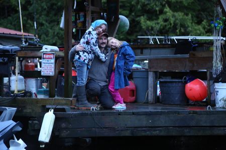 Cole Sturgis with his daughters, Timber and Willow on their float house. (BBC Studios Reality Productions, LLC/Lukas Taylor)