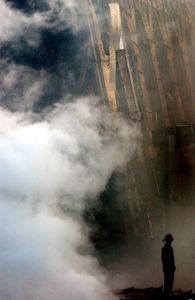 9/11: ONE DAY IN AMERICA - A solitary fire fighter stands amidst the rubble and smoke in New York City on September 14, 2001.  Days after a Sep. 11 terrorist attack, fires still burn at the site of the World Trade Center. (Photo Credit: U.S. Navy/Mate 2nd Class Jim Watson)