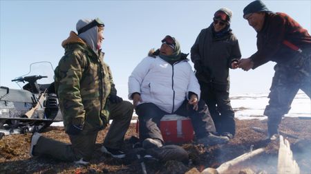 The Pingayak family eating a meal in the tundra. (National Geographic)