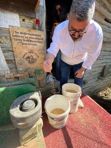 Baker Hakan Doğan examines heritage grains outside of a traditional mill in Iznik, Turkey. (National Geographic/Alex Pollini)