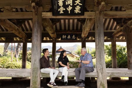 Antoni Porowski and Awkwafina meet with genealogy specialist Mark Peterson in Daeyul-ri, South Korea.(Credit: National Geographic/Seong Joon Cho)