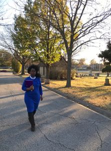 DeNeen Brown walks through Oaklawn Cemetery in Tulsa, OK. In October 2020, a team of archaeologists  uncovered unmarked mass graves in the cemetery, thought to belong to the victims of the 1921 race massacre. (National Geographic/Brandy Austin)