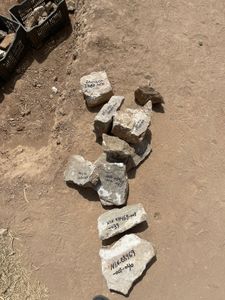 Fresh artefacts are given identifying codes at the Mosul dig site in Mosul, Iraq. (Windfall Films/Ali Hilal Ali Hussain)