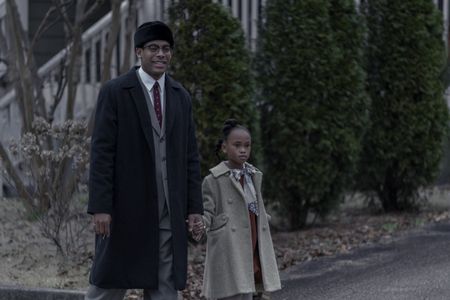 Malcolm X, played by Aaron Pierre, walks down the street with his daughter Attallah, played by Amani Summer, in GENIUS: MLK/X. (National Geographic/Zac Popik)