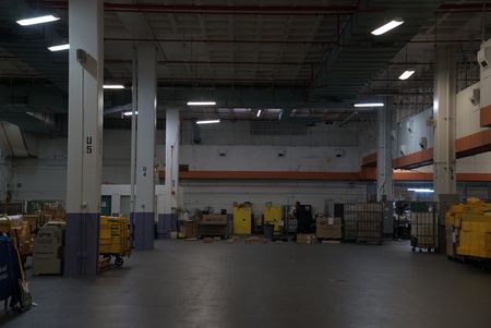 CBP Agriculture Specialist Joseph lays out shipped packages on the ground, so his K9 can inspect them for possible contraband in the JFK Mail Facility at the JFK International Airport, in New York. (National Geographic)