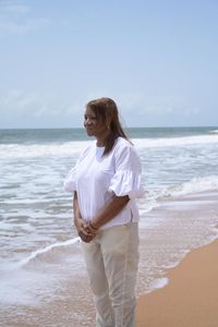 Cassandra Lewis stands in contemplative silence on Ouidah Beach, where her ancestor, Cudjo 'Kossola' Lewis, was taken in 1860. (National Geographic/Etinosa Yvonne)