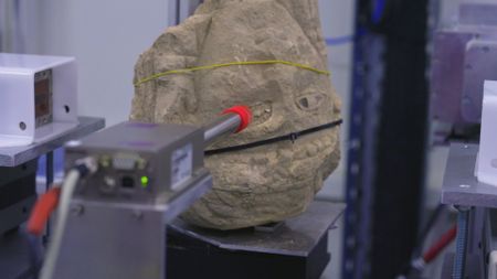 Once carefully removed from the ground, the stone head is transported to the Sesame Lab for extensive scans and research. (Windfall Films)