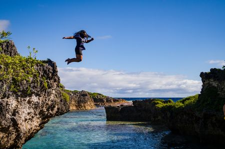 A Niuean girl leaps into Limu pools, popular natural swimming spots protected from the ocean by the limestone formations which surround them. National Geographic Pristine Seas explored the marine ecosystem in Niue -a small island nation in the tropical Pacific. Local and international scientists surveyed the ocean to understand its health and biodiversity. Thanks to local leadership, traditional knowledge, and strong science, the country has been able to protect large swaths of its marine environment.  (National Geographic/Nova West)