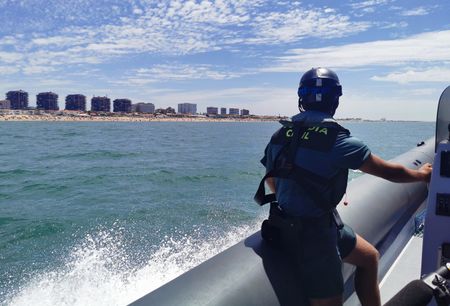 A Civil Guard officer watches the coast from a pneumatic boat. (National Geographic/Natalia Rodríguez Gil)