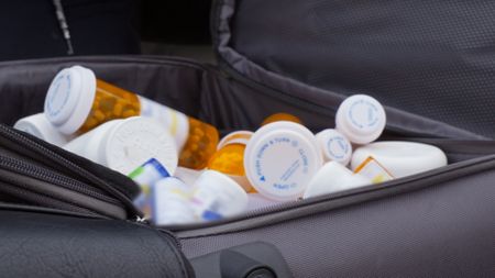 Pill bottles are found in a traveler's luggage after it was flagged by CBP officers in Newark, N.J. (National Geographic)