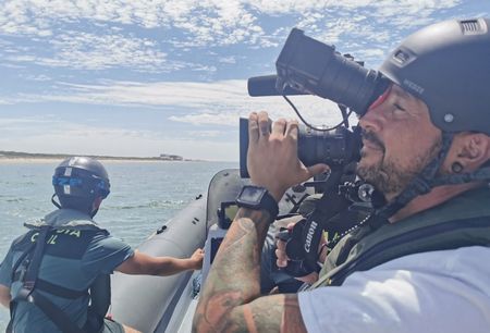 The film crew captures footage in a behind-the-scenes image on board a Civil Guard patrol boat in Huelva, Andalusia, Spain. (National Geographic/Natalia Rodríguez Gil)